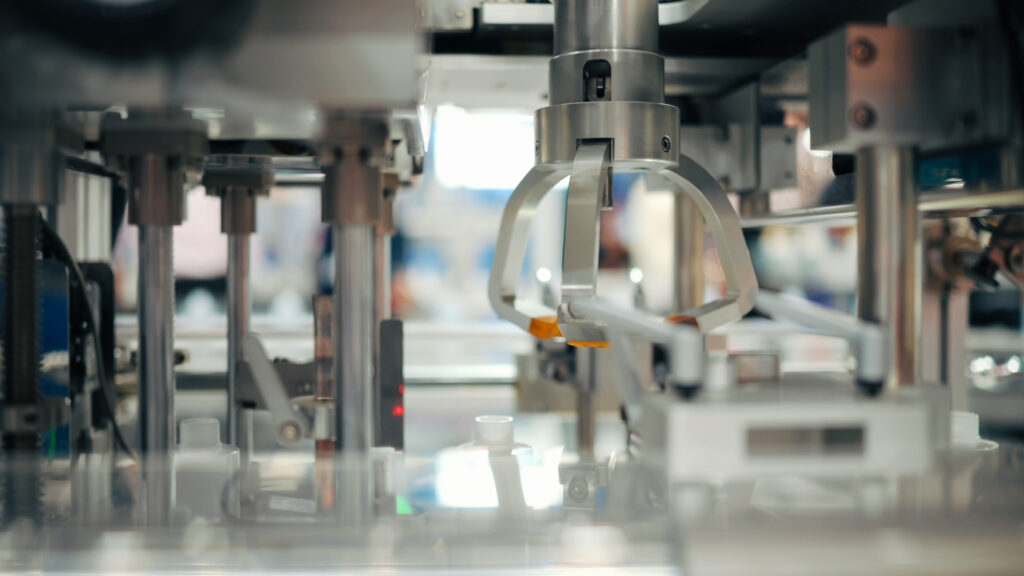 smart robotic system filling small bottles on conveyor in automated phamaceutical technology packaging manufacturing line | precision filling and capping system for cosmetic or medical production
